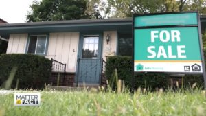 for sale sign in front of house