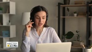 Woman with headset presumably listening to a conference call