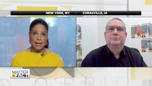 Soledad O'Brien in yellow speaking with Paul Iversen from the University of Iowa