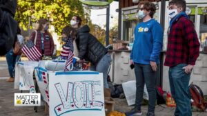 college voters in front of a registration booth