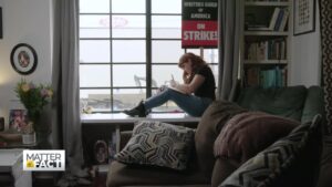 WGA writer with strike sign