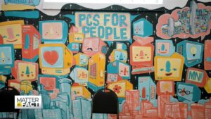 black chair in front of PCs for People mural