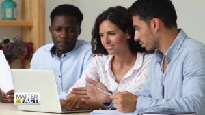 young professionals looking at a laptop